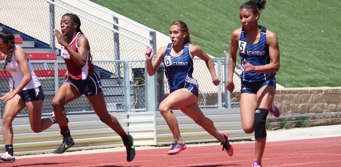 Track and field runners compete on the track.